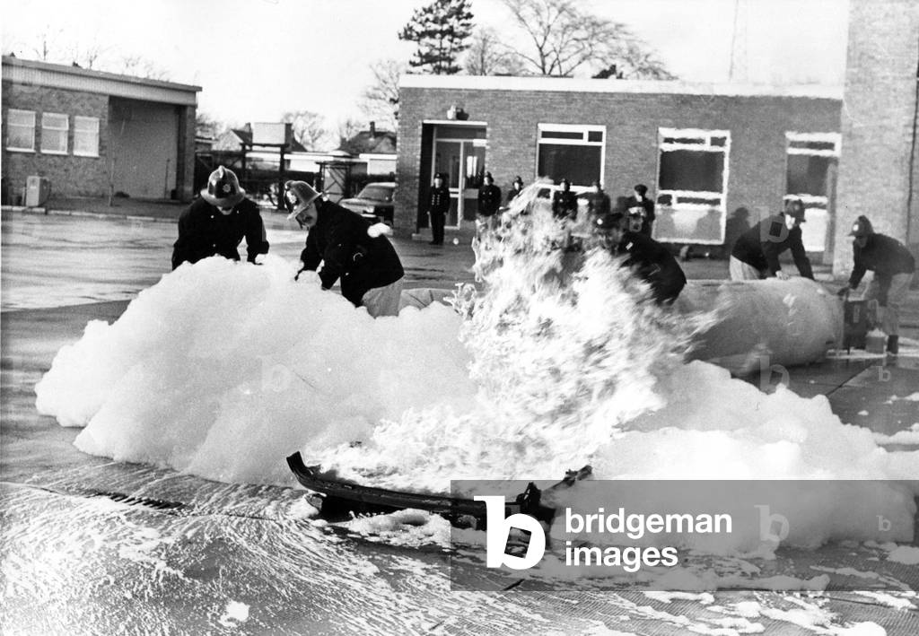 Firefighters in a training exercise in North East - putting a blaze out with foam, 1970