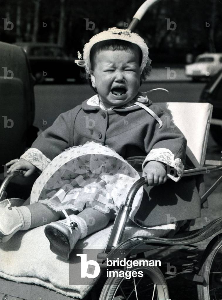 Fifteen month old Dianne Susan Worzella whose father is an American airman stationed in the UK, greets the first real sunny day with a howl in the Mall. April 1958