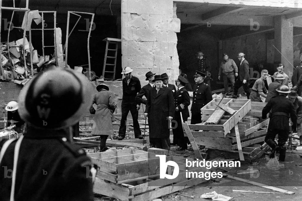 Prime Minister Winston Churchill at Tufton Street, Westminster at an incident caused by a robot plane. 
July 1944