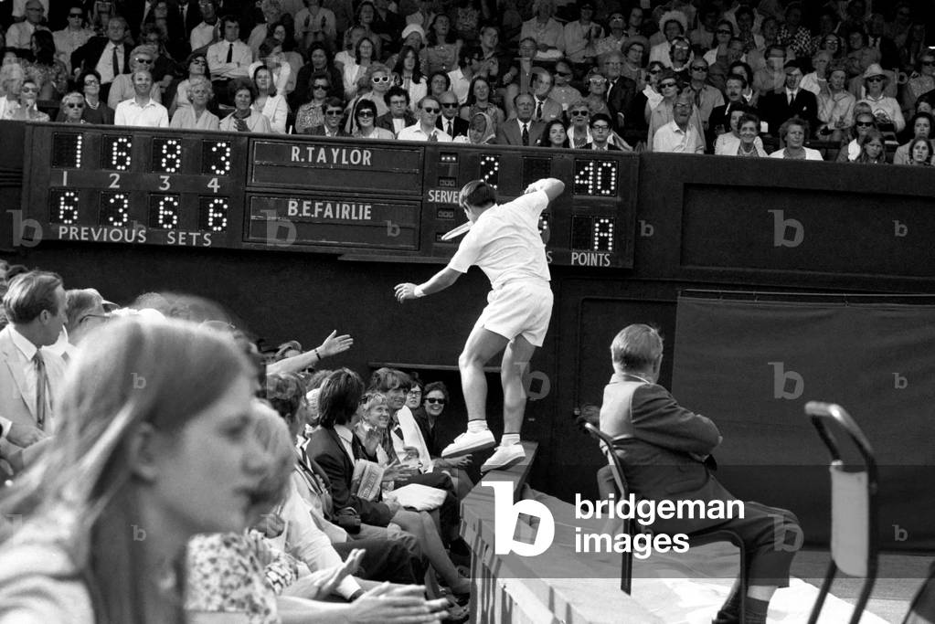 Wimbledon Tennis Championships 1970 1st Day. B. Fairlie rushes to get to shot by Taylor - misses it - nearly ends up among Spectators. June 1970