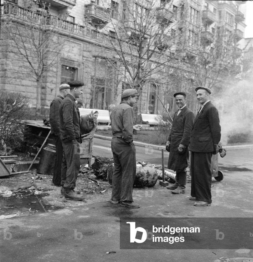 Street cleaners take a cigarette break while at work in one of the residential streets in the Soviet city of Kiev
May 1960