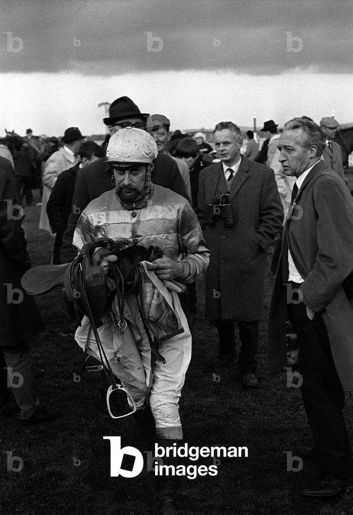 Jockey Clement Freud who was riding Saxon King at Naas racecourse in County Kildare Eire seen here walking towards the weighing room. Circa April 1967 (b/w photo)