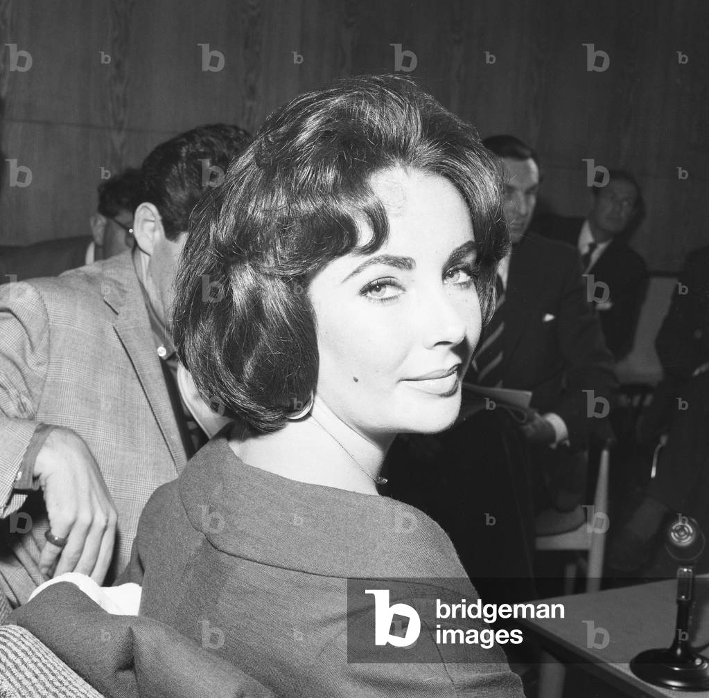 Actress Elizabeth Taylor seen here during a press conference with husband Eddie Fisher at London Airport 26th May 1959