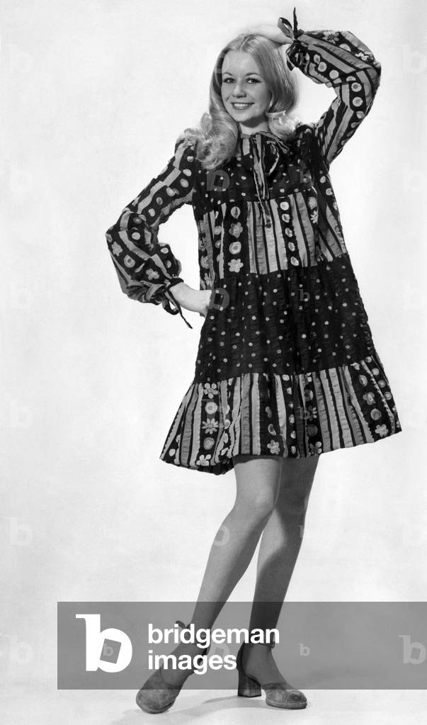 Jenny Clare models this pretty smock frock in rainbow colours by Ossie Clark for Radley. I has ties at the neck and wrists. 
March 1972