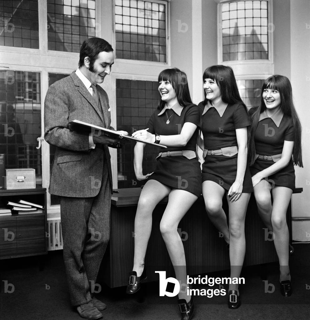 The singing Karlins Evelyn, Elaine, and Linda have just helped make a new record for the manager of the Langham branch of Abbey Life Insurance. They have just taken out a policy for £70,000 which has given Mr. Clive Holmes a total of over £1,000,000 of business for the month. L-R (girls) Evelyn, Elaine and Linda with Mr. Clive Holmes in his office in Margaret Street, W1. This morning. November 1969
