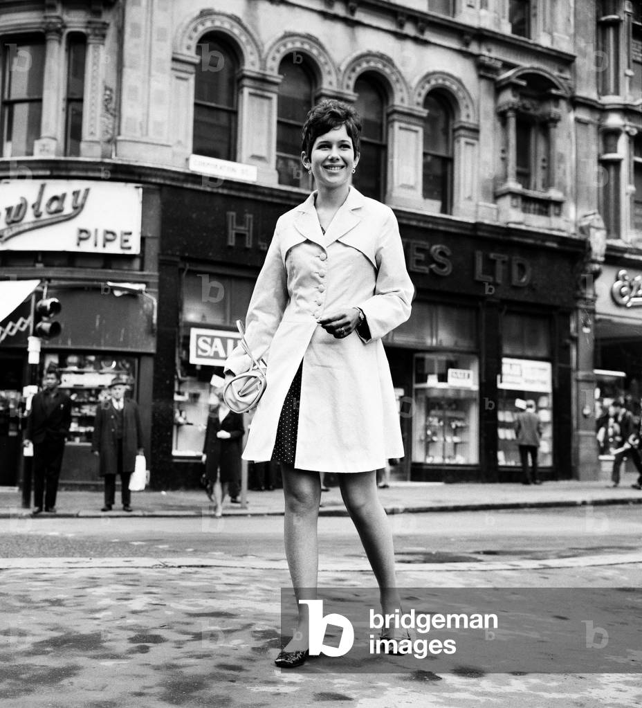 Gorgeous Girls. Miss Imir Westwood, aged 19, who works in a china department in Corporation St, Birmingham. On her way to work, 19th September 1967 (b/w photo)