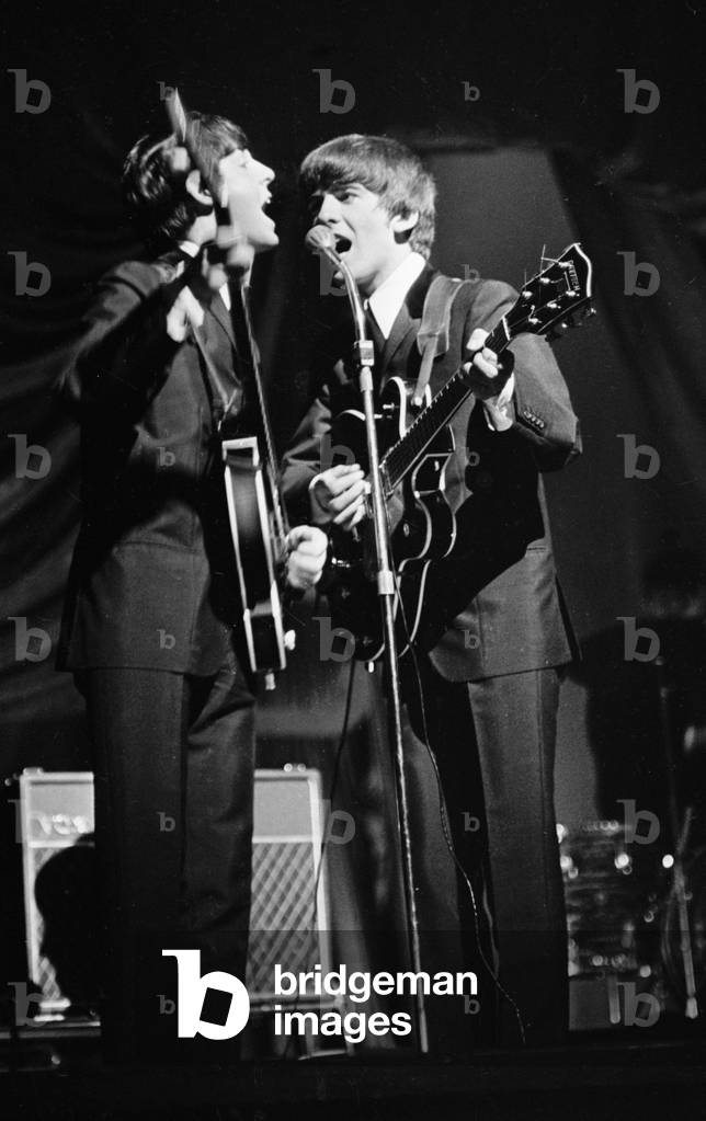 Paul McCartney and George Harrison of The Beatles performing on stage in Carlisle, 21st November 1963 (b/w photo)