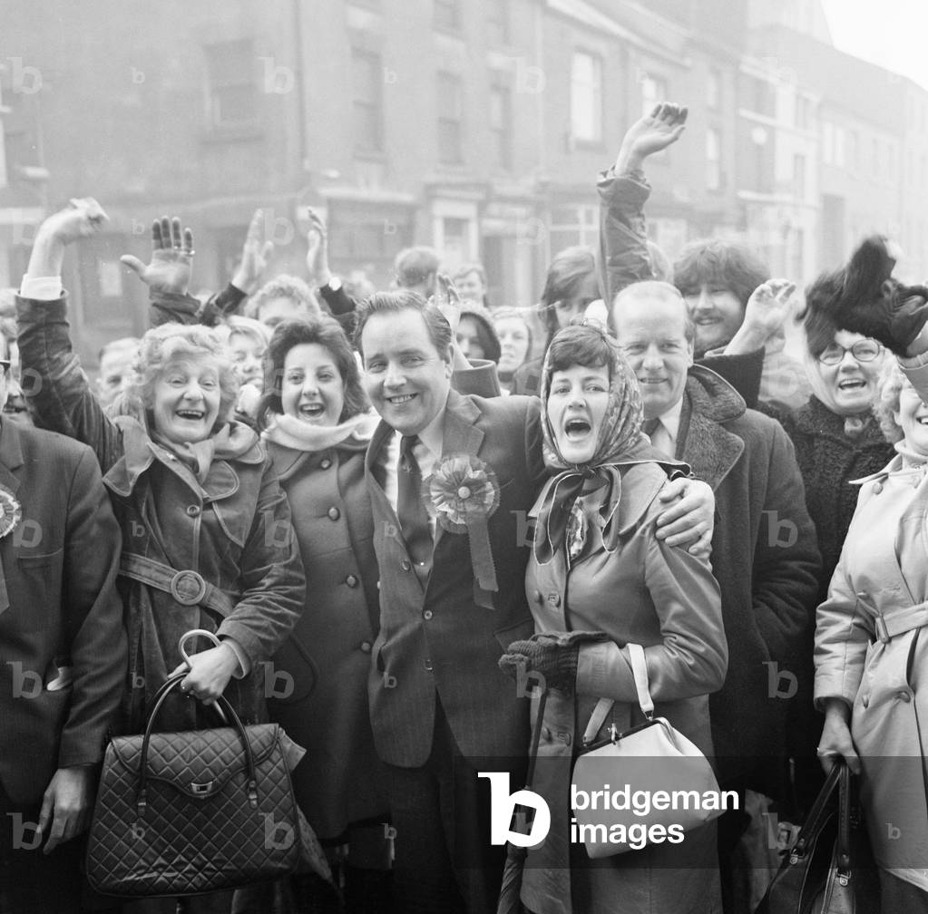 George Rodgers, celebrates after winning, new Labour Member of Parliament for Chorley, pictured with supporters outside Chorley Town Hall, Lancashire, in North West England. 1st March 1974 (b/w photo)