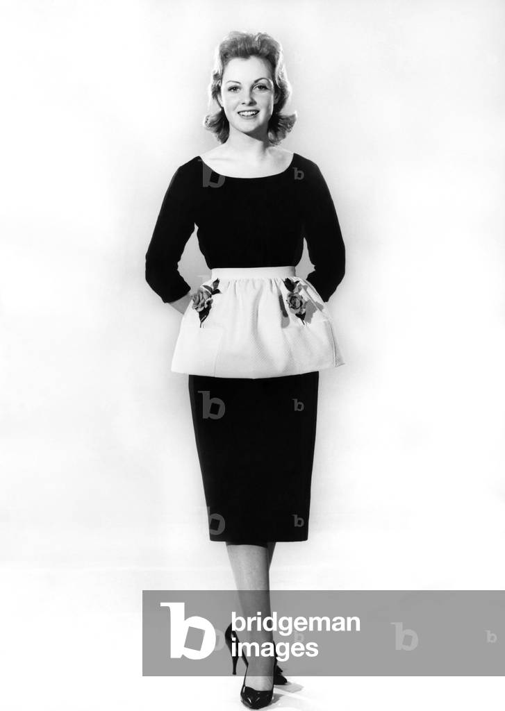 Reveille Fashions. Mannequin modelling dress and apron .March 1960 (b/w photo)