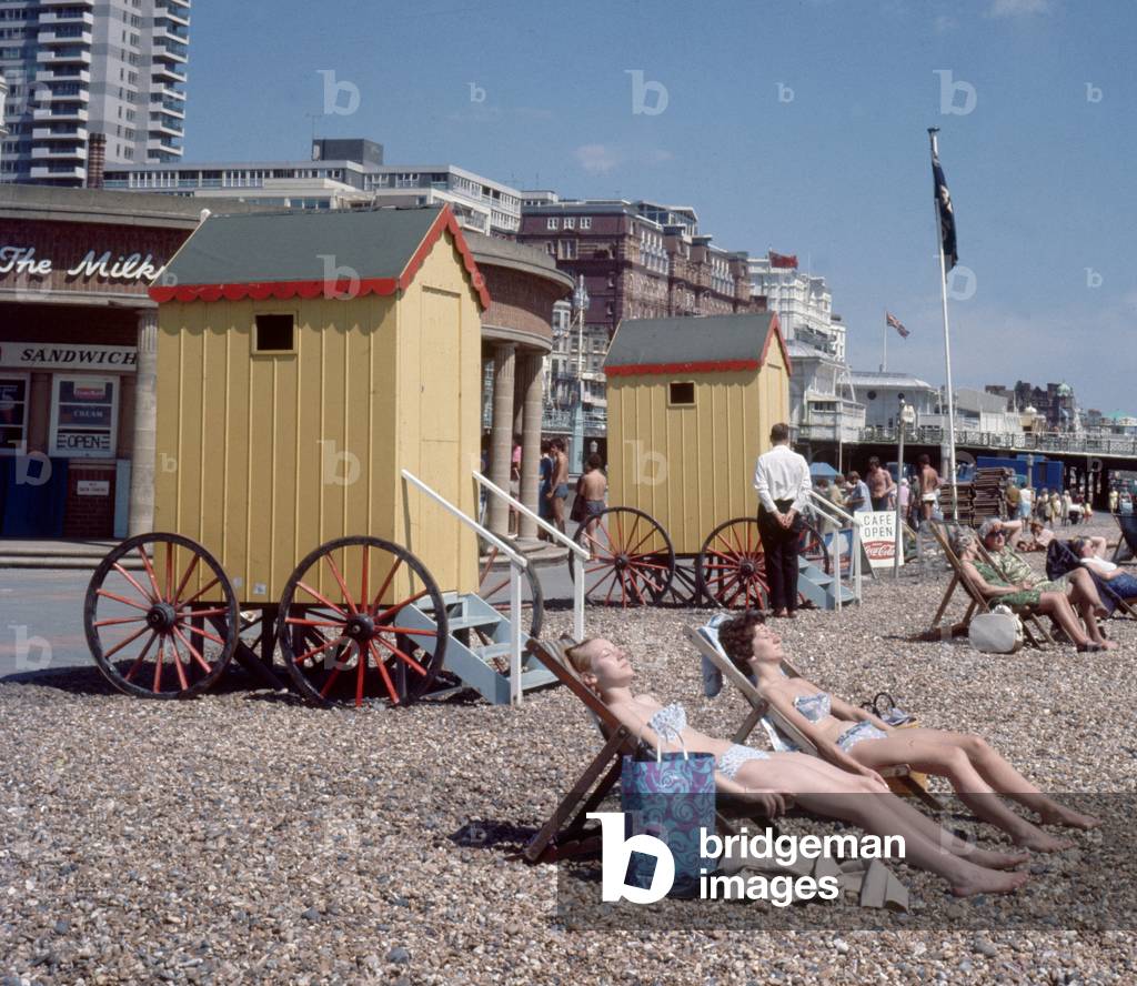 Old style bathing huts on the sea front at Brighton. 1st June 1968