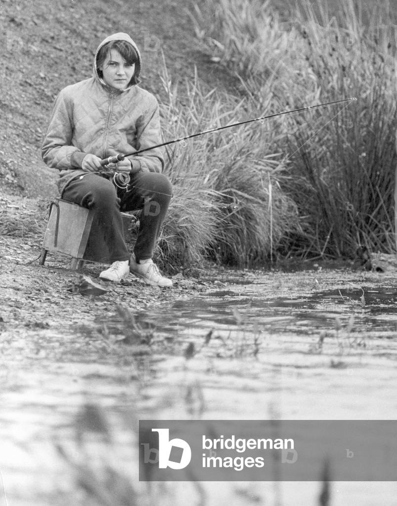 Dora Houston seen here fishing close to her home in Wigan, hoping to land another three foot long pike, 11th September 1966 (b/w photo)