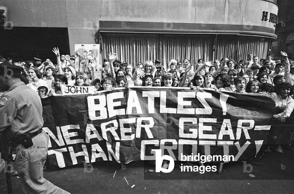 The Beatles in New York City, on their North American Tour ahead of their concert to be held at Forest Hills. Cheering fans gathered outside the Delmonico Hotel in New York where the band are staying. 28th August 1964 (b/w photo)