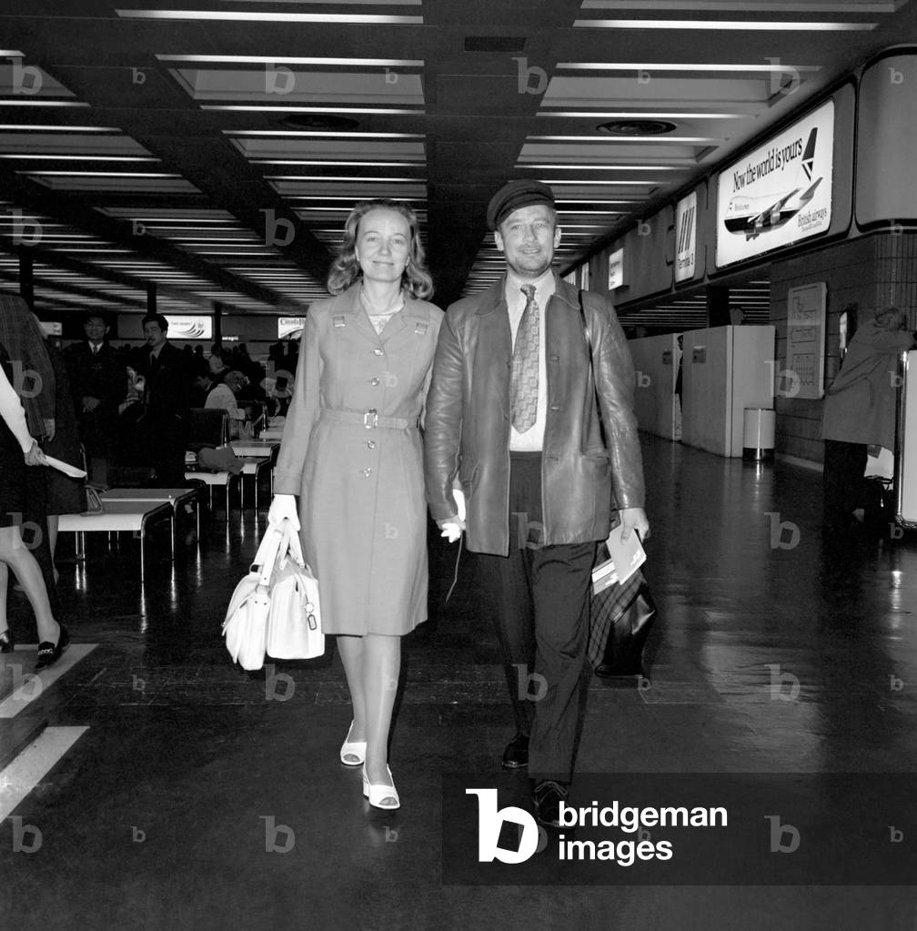 Edward Woodward actor with his wife (first wife), actress Venetia Barrett at London Heathrow Airport 1st May 1974 (b/w photo)