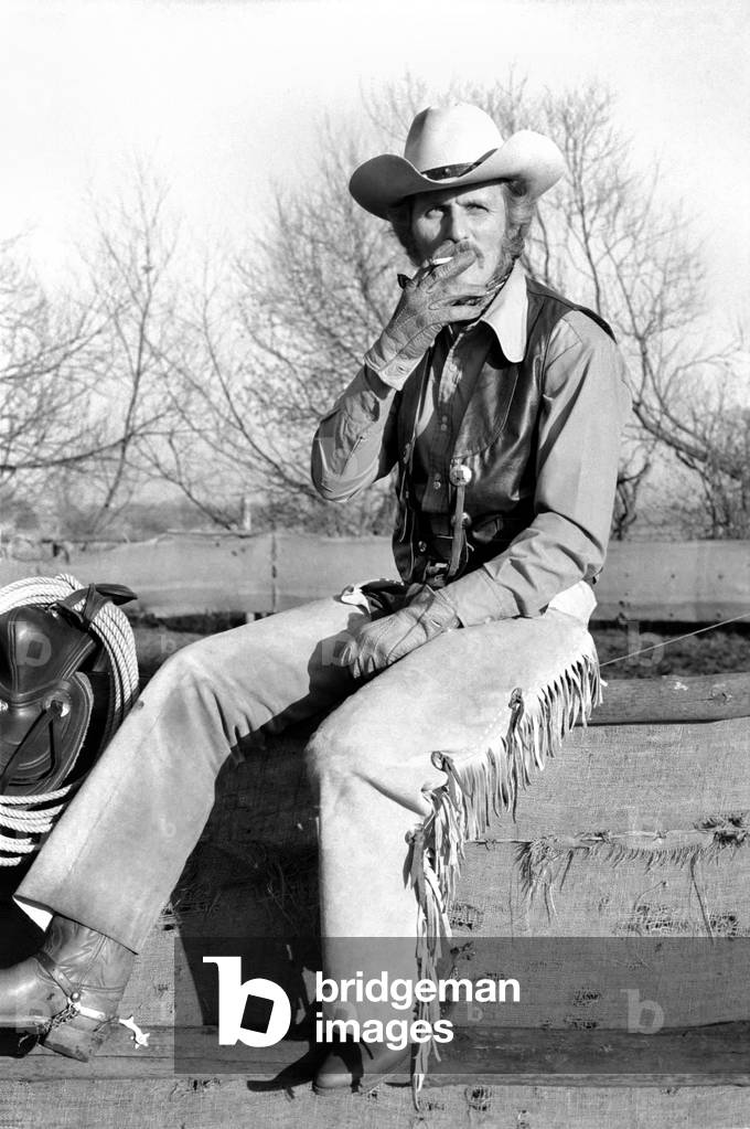 Farmer Bill Frith of Appledore, Kent, in cowboy dress and spurs, with his American Quarter horse stallion, 28th February 1975 (b/w photo)