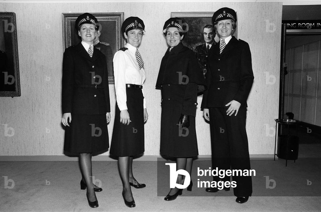 The new Police image. W.P.C Leslie Cosburn, left, (21) from Bow shows off the stylish new uniform and reflecting the modern 1977 Police image, alongside W.P.C's Sylvia Man, Carol Price and Julia Hawkins. 6th December 1977 (b/w photo)