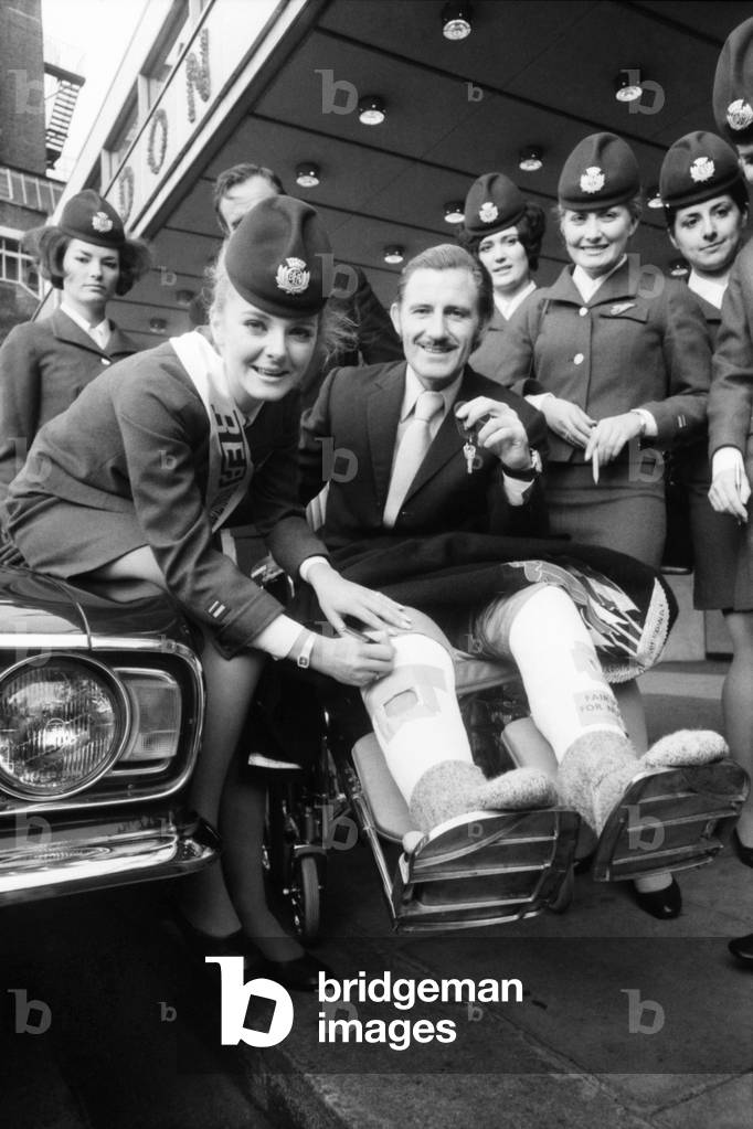 BEA's 'Personality Girl', Heathrow Airport stewardess Heather Angus (21) from Gerrards Cross, Bucks, at the London Hilton Hotel received the keys of her prize, a Ford Cortina 1600E from racing driver Graham Hill. Bea Personality Girl, Heather Angus with Graham Hill. November 1969