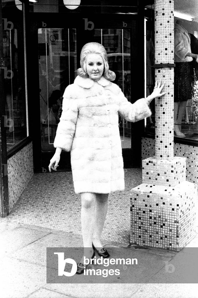 A model wears a fur coat during a fashion shoot, 2 May 1970 (b/w photo)