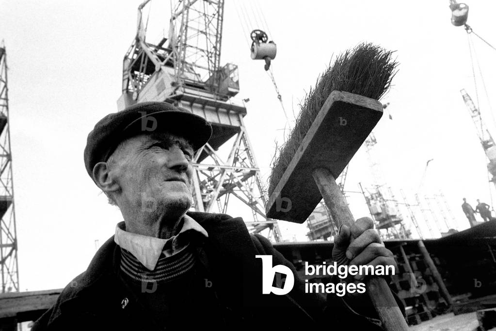 The Vistafjord passenger cruise liner having her keel laid on the first day being built for Den Norske Amerikaline a/s Oslo, by Swan Hunter Shipbuilders Ltd., Wallsend. A shipyard worker surveys the scene., 19/04/1971 (b/w photo)