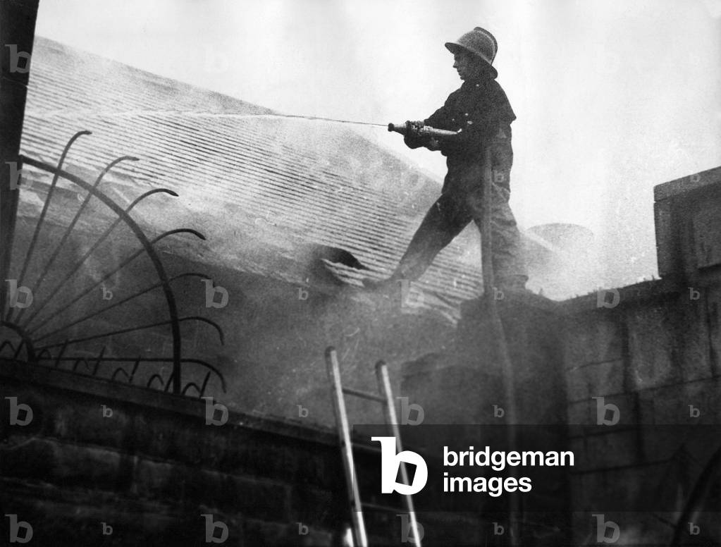 Firefighters clambered over the roofs high above the city to tackle a blaze that threatened to sweep through buildings in the town centre, 1970