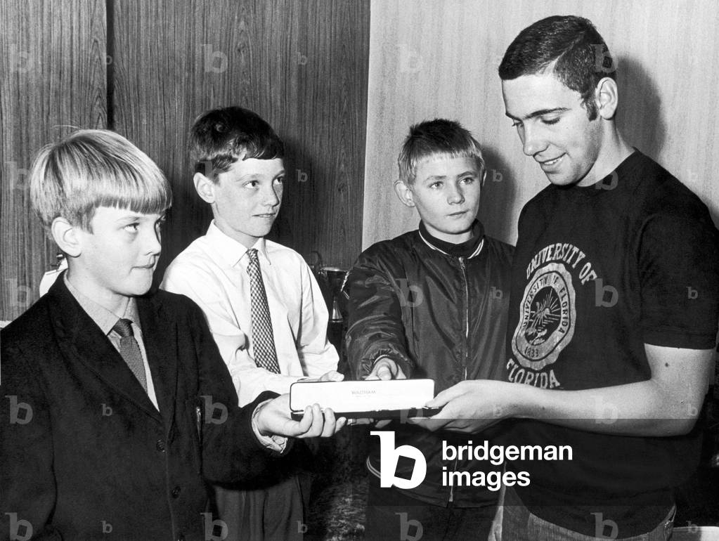The Olympic silver medal swimmer Martyn Woodroffe, 18 years old, who had his watch stolen during the Mexico City games, receiving a new watch from his friends and neighbours. Cardiff, 29th October 1968 (b/w photo)