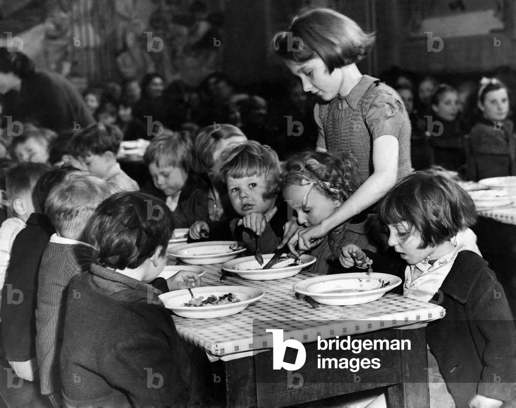 Eileen Meakin, aged 13, with some of her little charges at a Hoxton Children's Feeding Centre. June 1942 P012684