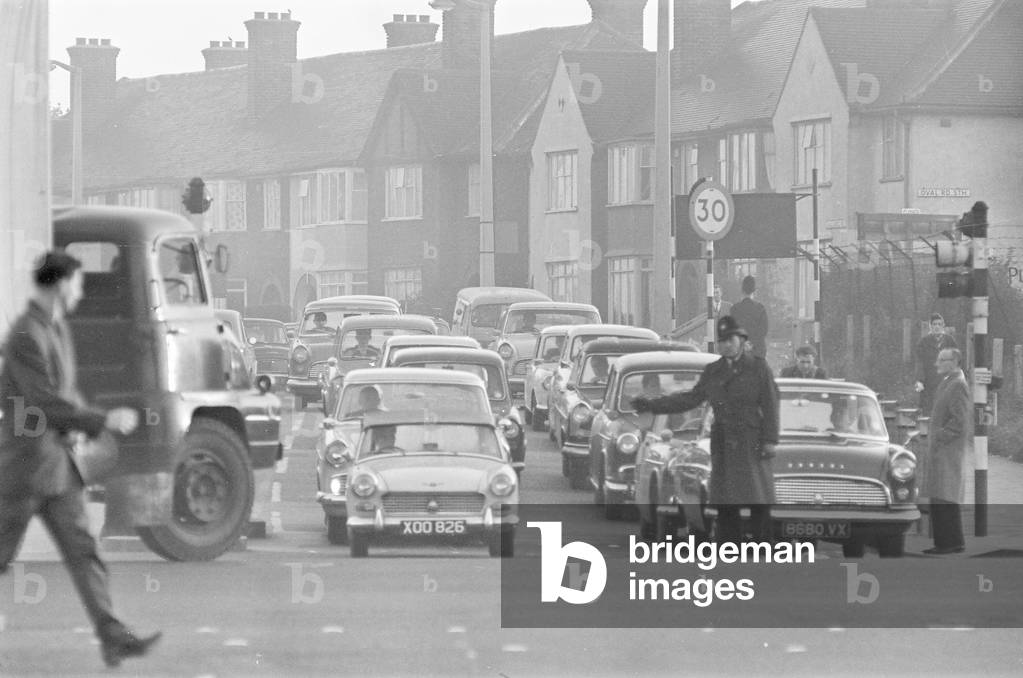 Traffic in Dagenham as the Ford factory turns out at the end of the day shift. 2nd October 1963 (b/w photo)