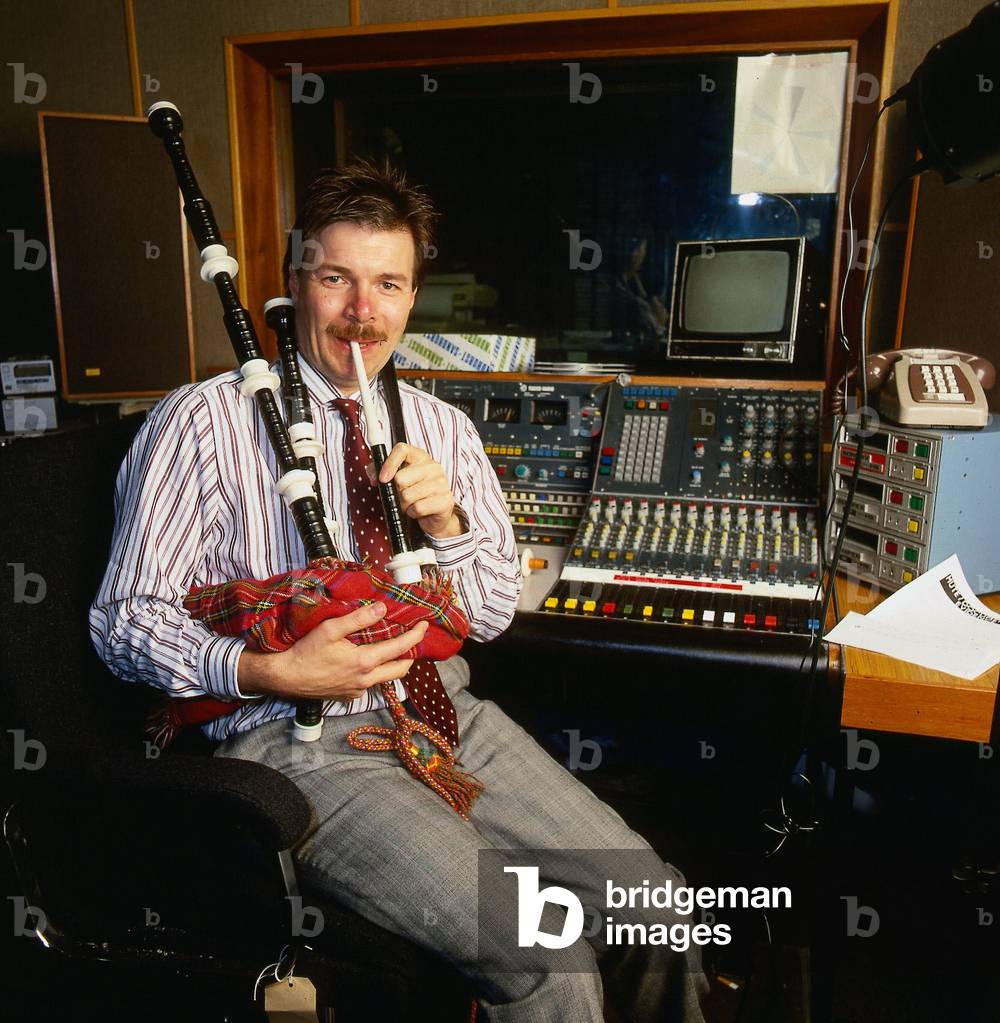 Richard Park DJ Disc Jockey for Radio Clyde playing the bagpipes, November 1987 (photo)