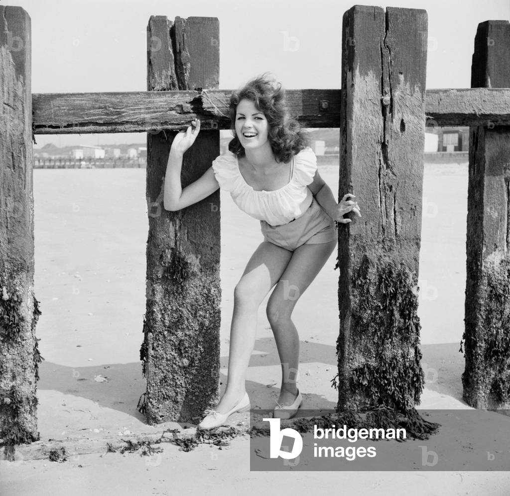 Beach Glamour: Having holiday fun in the sun at Minnis Bay near Margate, Kent. are girl with dark hair (A red head) Beverley Bennett age 18 and Blonde Ingrid Young age 16 both girls are actresses at the Adia Foster School. June 1960