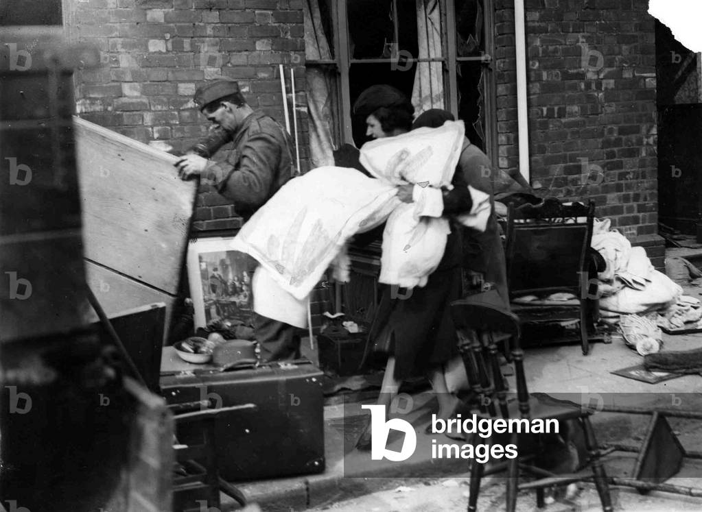 Householders salvage goods from a bombed area in Cardiff following a German air raid. May 1941.