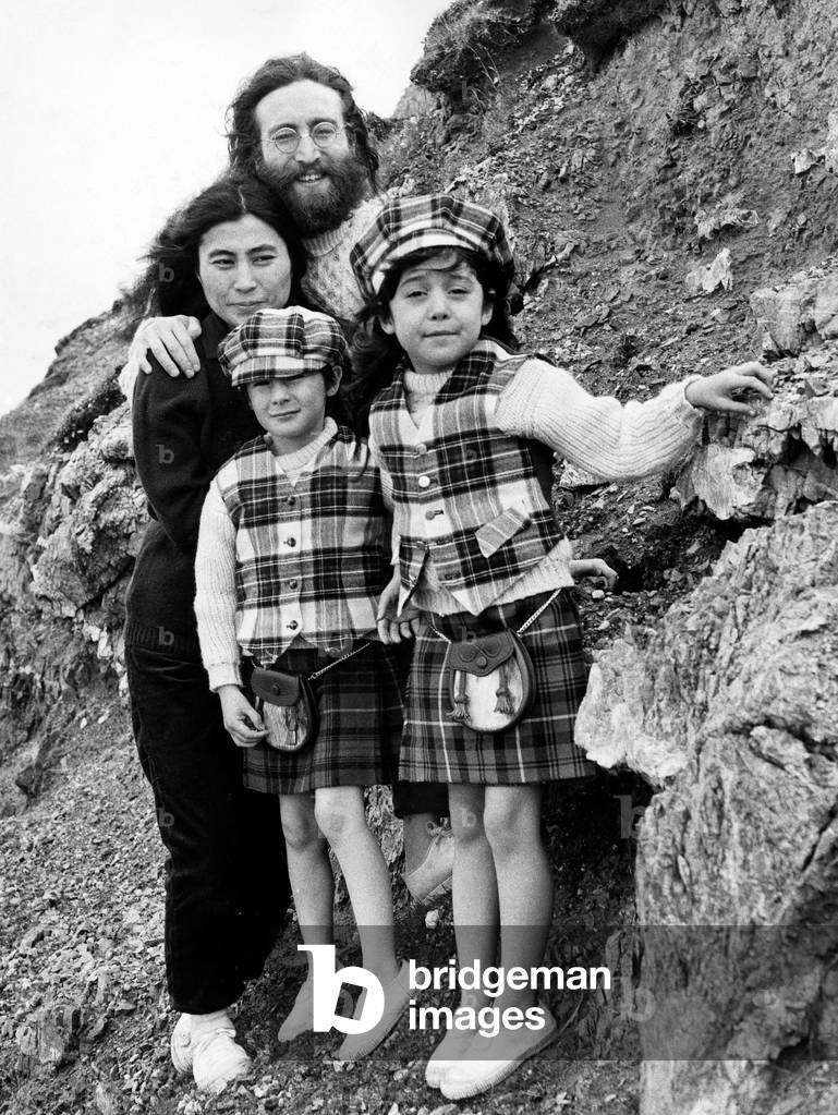 Yoko Ono and John Lennon stand on mountain side with Julian Lennon and Kyoko. Both children dressed in kilts tartan caps and waistcoats Pictured 2nd July 1969 (b/w photo)