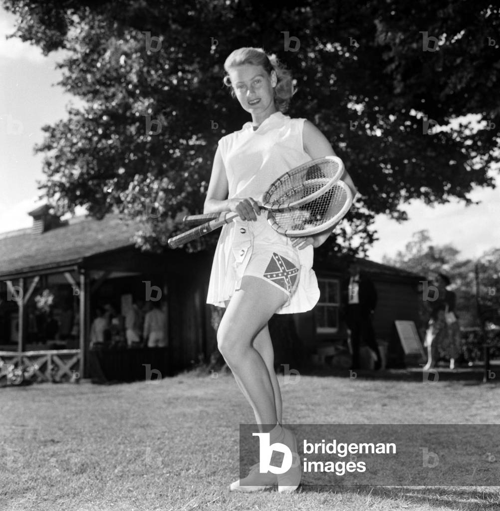 Lawn Tennis at Beckenham. 
Woman holding a tennis racket wearing a sports dress before a match at the club
June 1960