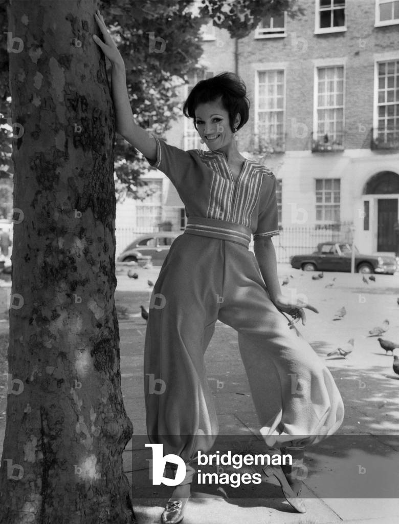 Fashion 1960's. Stevie Whittington in a Ali Baba Harem suit in tangerine and wool crepe by Nettie Vogue price 41 gns. June 1967