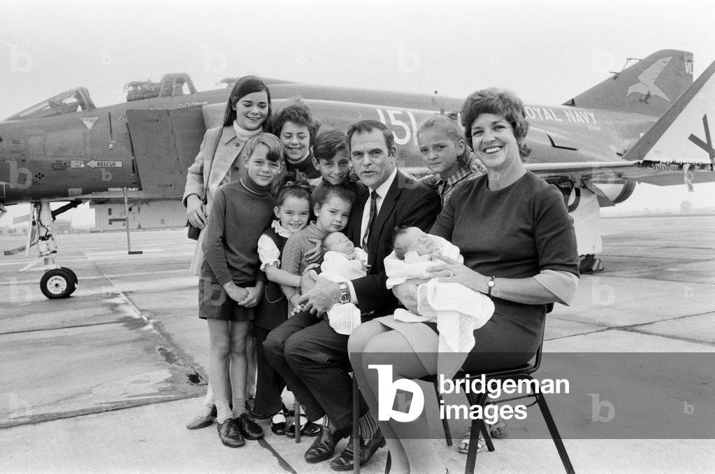 Lieutenant Commander Peter Marshall of HMS Ark Royal and his wife Carolyn, both holding their new born baby twin boys Paul and Mark, pose with their other eight children Kathryn, Ginny, Richard, Melanie, Sally, Carl, Kirstie and Christopher. 24th August 1971 (b/w photo)