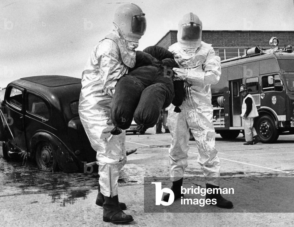 Britain's most modern motorway rescue tender went into action at Durham. Firefighters in astronaut-style protective suits fought their way throught the smoke and wreckage of a two car crash. Of course the victims were just dummies as the team take part in a training exercise, c.1970