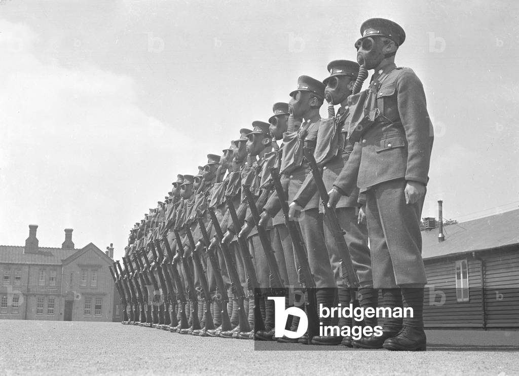 Members of the local regiment seen here on parade wearing gas masks, 
01/08/1938