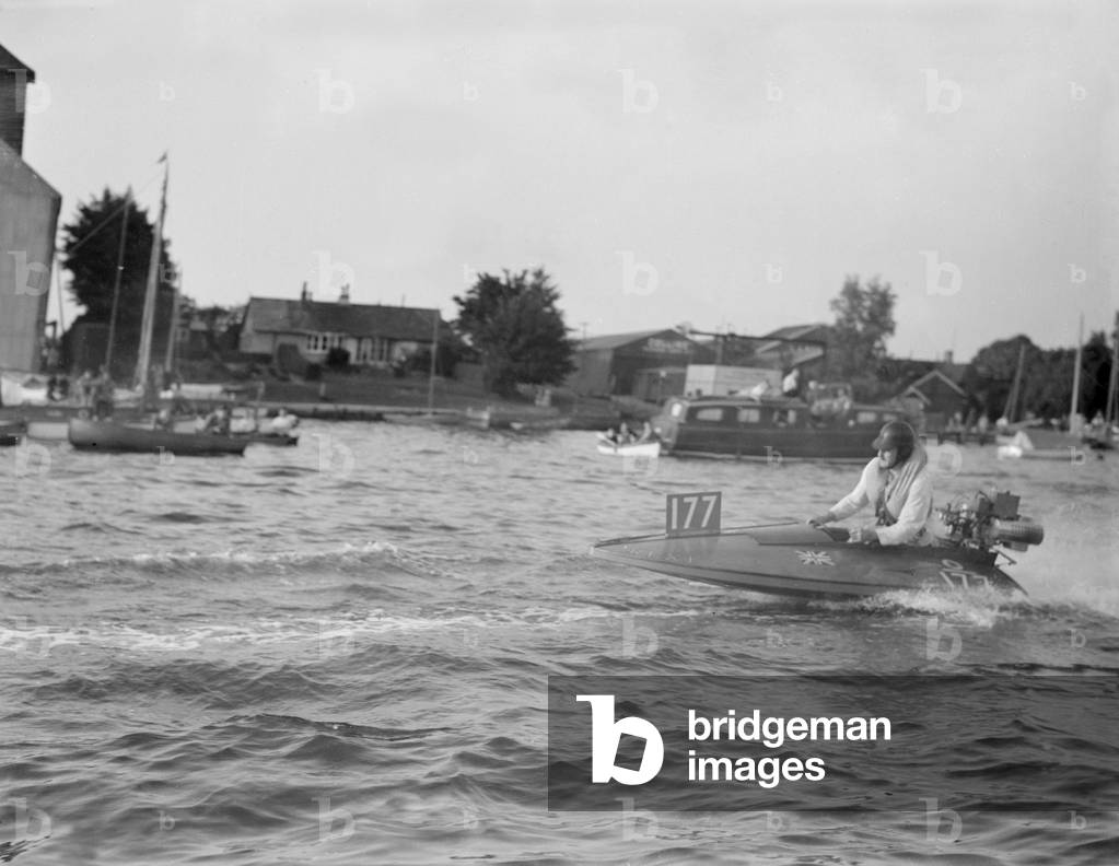 Competitor taking part in the Daily Mirror Handicap Trophy Race for outboard hydroplane on Oulton Broad in Suffolk. 6th August 1953 (b/w photo)