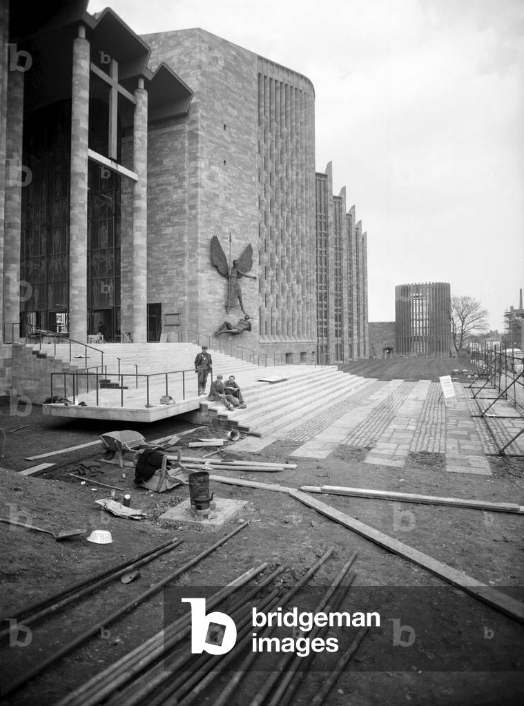 Craftsmen put the finishing touches to the new Coventry Cathedral which stands alongside the old Cathedral which was destroyed in the war, c. March 1962 (b/w photo)