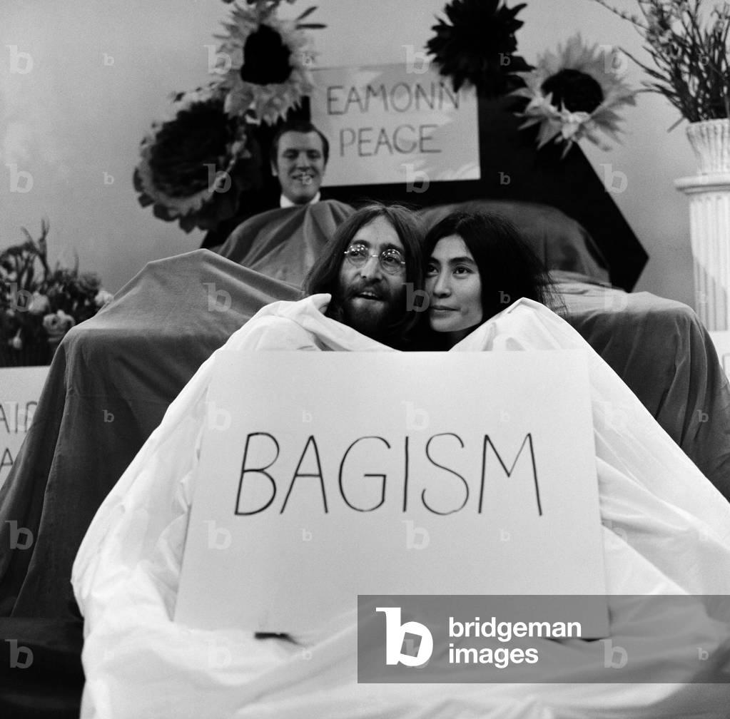 John Lennon and Yoko Ono appear on Thames Television's 'Today' programme with Eamonn Andrews. Eamonn started the programme in a bed and was joined by John and Yoko who emerged out of a bag at the bottom of the bed. 1st April 1969 (b/w photo)