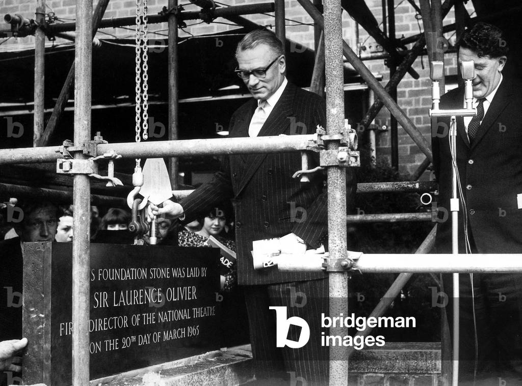 Sir Laurence Olivier formerly lays the foundation stone at the Belgrade Theatre watched by Alderman Arthur J. Waugh, chairman of the Belgrade Theatre Trust. 20th March 1965 (b/w photo)