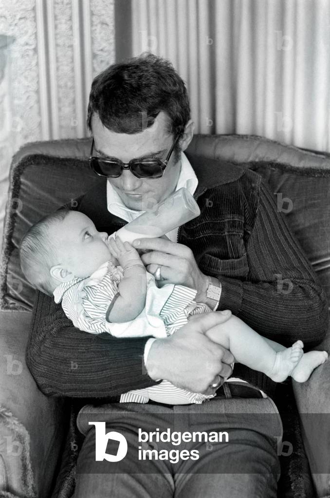 Boxer Alan Minter pictured at his Crawley Sussex home with his six month old baby daughter Kerry, April 1977 (b/w photo)