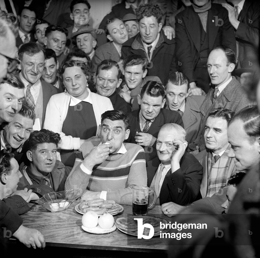 Miner Joe Steele seen here taking part in a food eating competition, January 1958 (b/w photo)