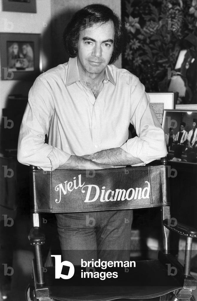 Neil Diamond pictured at his office in Hollywood with his film chair. 
5th December 1980.