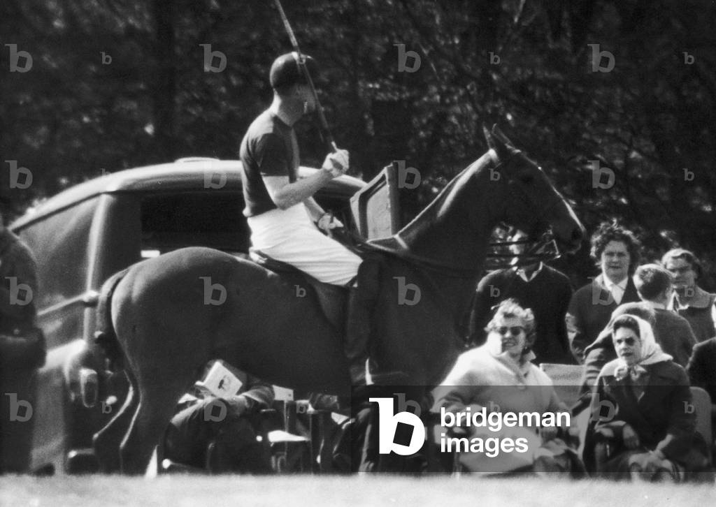 The Queen watching The Duke of Edinburgh playing Polo at Windsor soon after the birth of Prince Edward.
4th May 1964.