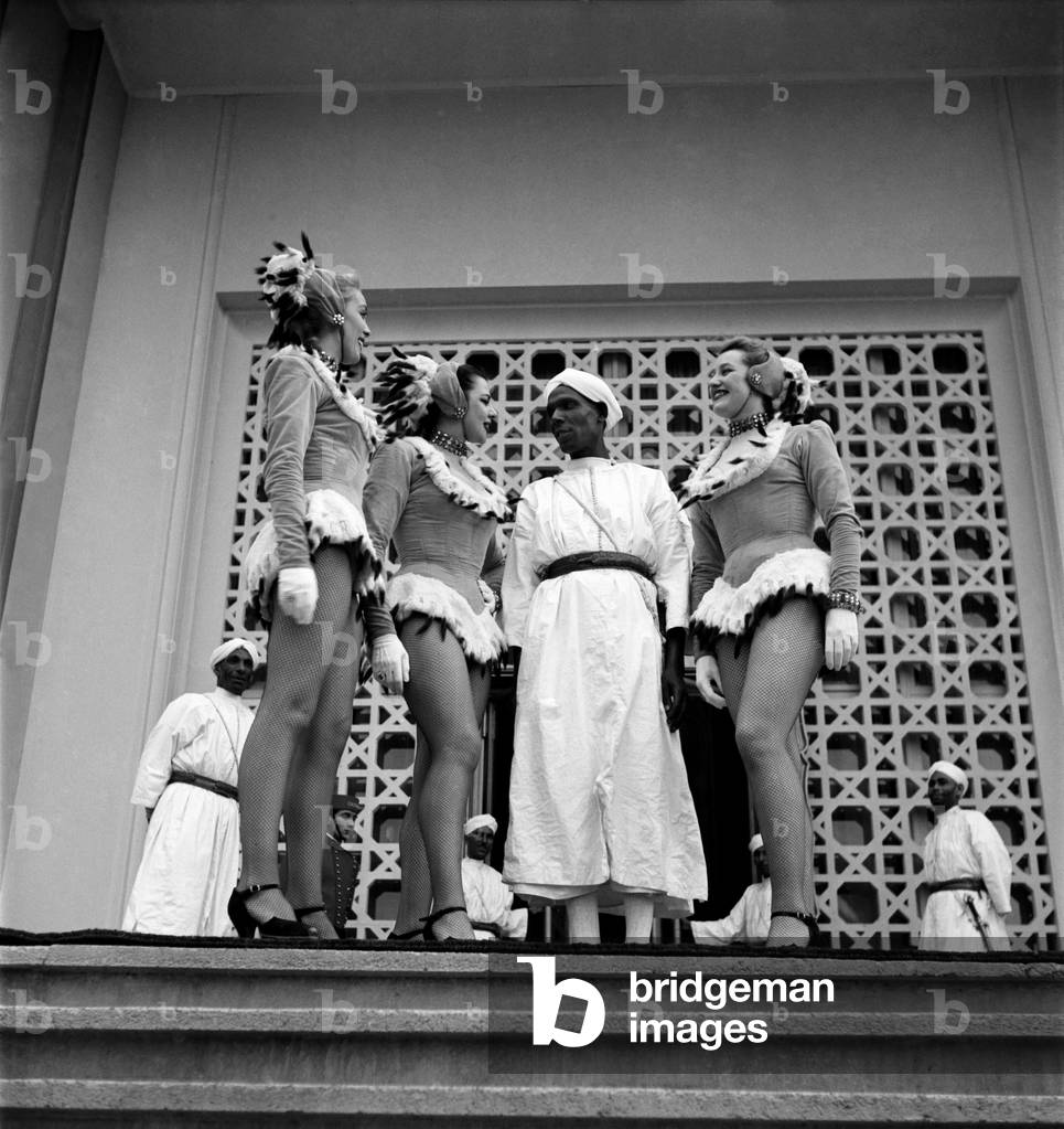Politician Berber Pasha (Thamil el Galoui) meets women dancers 
on the steps of the Casino in Marrakech, Morocco.
December 1952 
C5919-008