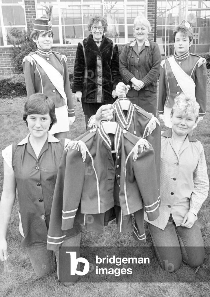 Going for a burton has paid off for an East Cleveland juvenile jazz band, for two trainees at Guisborough's Burtons clothing factory have helped stitch up the Loftus Greenjackets with new uniforms. Seamstresses Gillian Hird, 17 and Debbie Goodall, 16, have been making 56 jackets and sashes for the band while working at the factory on a youth training scheme and yesterday the uniforms were handed over to the band. Burtons personnel officer Barbara Jacobs said Burtons supplied the labour and the band supplied the material. Pictured L - R Gillian Hird (17) YTS, Claire Boyes (12) Loftus Greenjackets Jazz band, Ruby Campbell, who organises events for the band, Lucy Autill, training instructress at Burtons, Melanie Smith (14) jazz band and Debbie Goodall (16) YTS. 20th March 1984 (b/w photo)