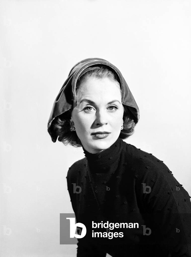 Clothing: Fashion: Hats: Woman wearing unusual hat, 1960 (b/w photo)