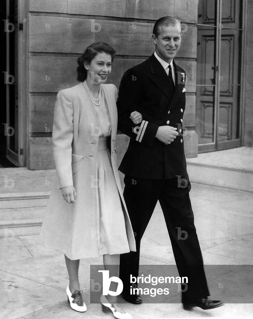 Princess Elizabeth and her fiance Lieutenant Philip Mountbatten announce their engagement arm in arm at Buckingham Palace, 10th July 1947