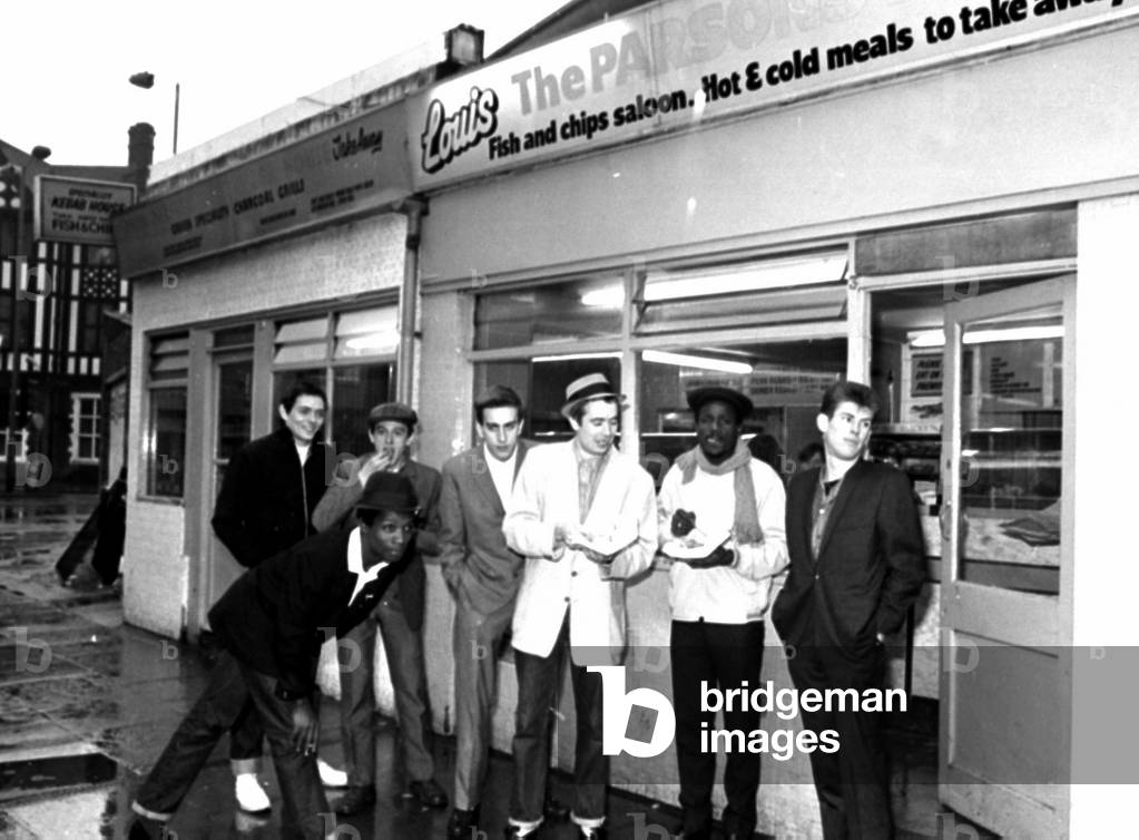 The Specials pop group in chip shop called 'The Parson's Nose' in Bishop Street, Coventry.
