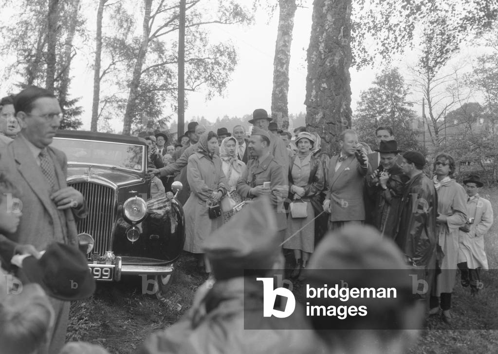 The Queen (centre) seen here with Princess Margaret and members of the Swedish Royal family arriving to watch the action in the cross country stage of the 1956 Equestrian Olympic Games three day event at Jrvafelt Nature Reserve, Sweden 11th June 1956 (b/w photo)