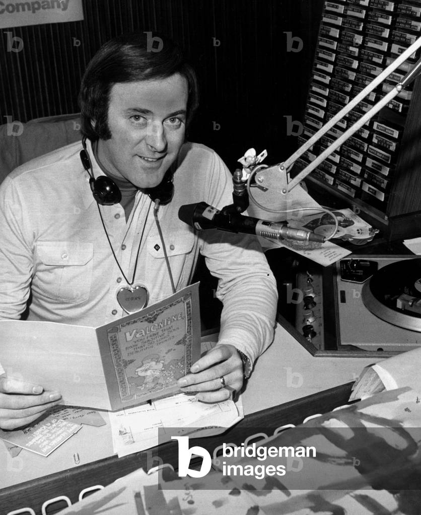 BBC Radio broadcaster Terry Wogan reading a Valentines card at his desk at the BBC